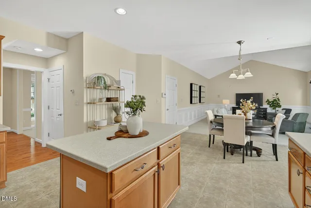 a kitchen with a sink a stove a refrigerator a center island and a cabinets