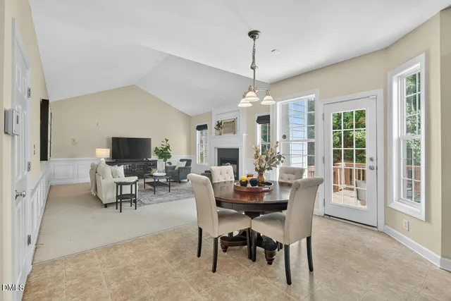 a dining room with furniture and a large window