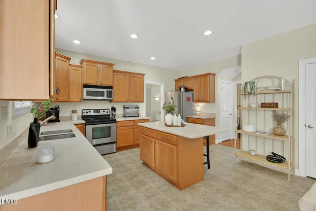 a living room with furniture a flat screen tv and a window