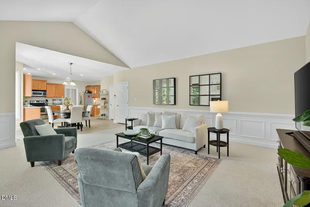 a bedroom with a bed and a lamp on dresser next to a window