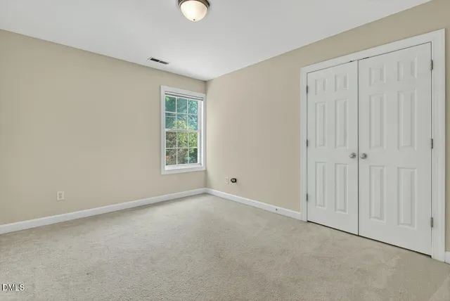 a view of a house with a tree in the background