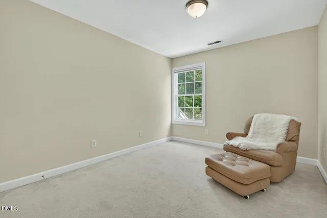 a view of a house with a small yard plants and large tree