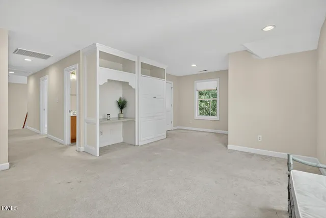 a view of a house with a yard and large trees
