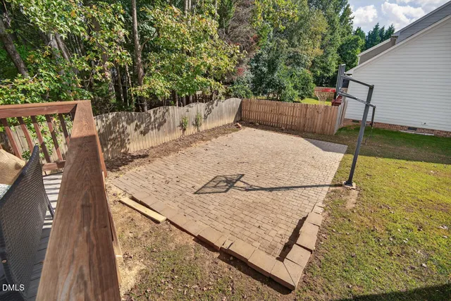 an aerial view of a house with a yard and large trees