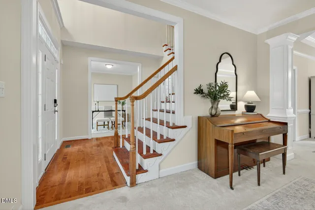 a view of entryway and hall with wooden floor