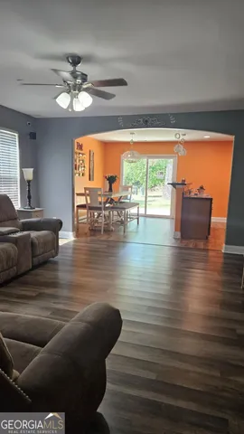 a dining room with furniture and wooden floor