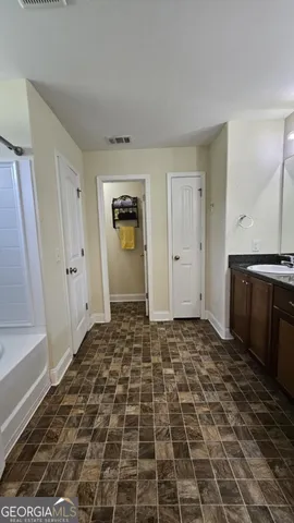 a spacious bedroom with a bed and a couch