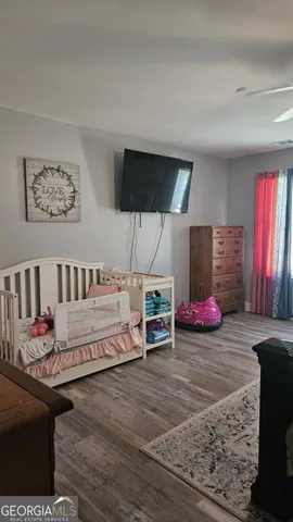 a bedroom with furniture and a wooden floor