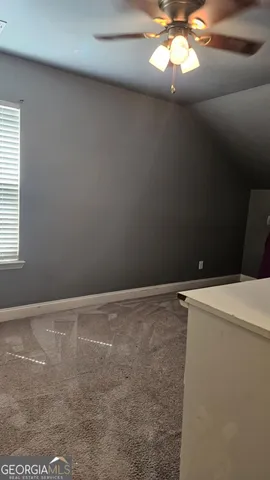 a bedroom with a bed and a night stand