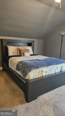 a bedroom with furniture and a wooden floor