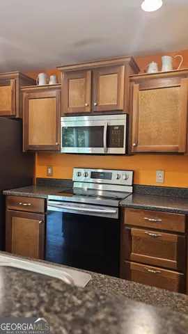 a living room with a table and paintings on the wall