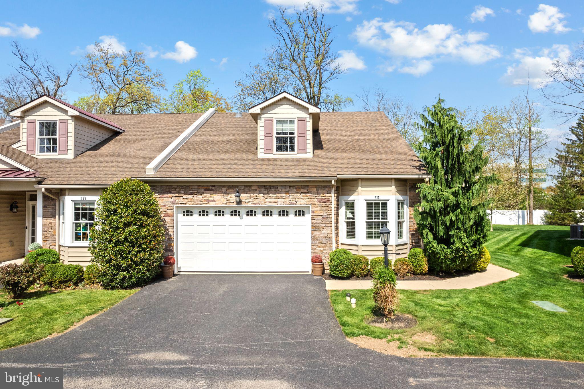 587 East Township Line Road, Unit 1 Blue Bell, PA 19422 - Photo 2 of 33 Charming home with lush greenery.