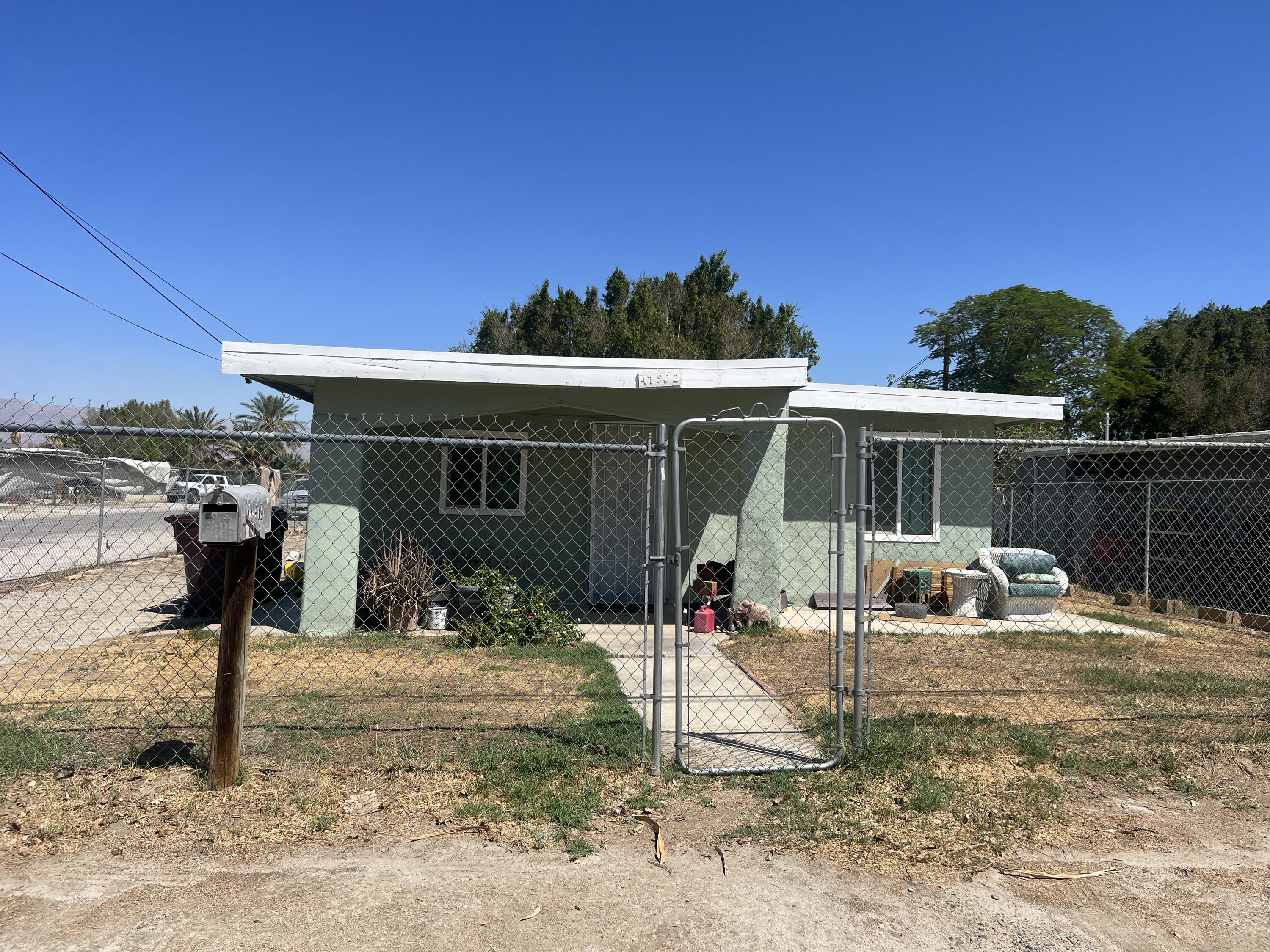 47902 Luzon Street Indio, CA 92201 - Photo 1 of 11 a front view of a house with a yard