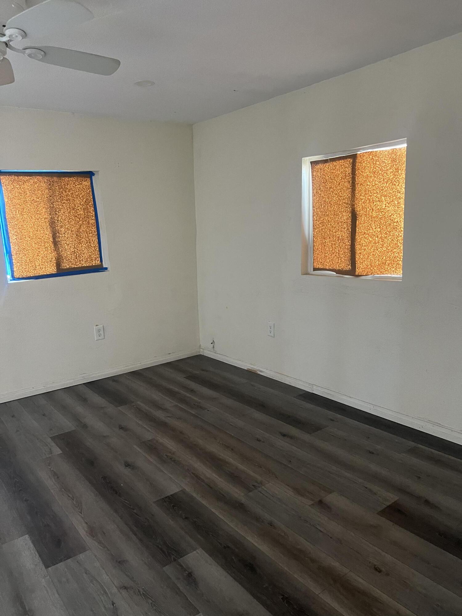47902 Luzon Street Indio, CA 92201 - Photo 5 of 11 a view of empty room with wooden floor and fan