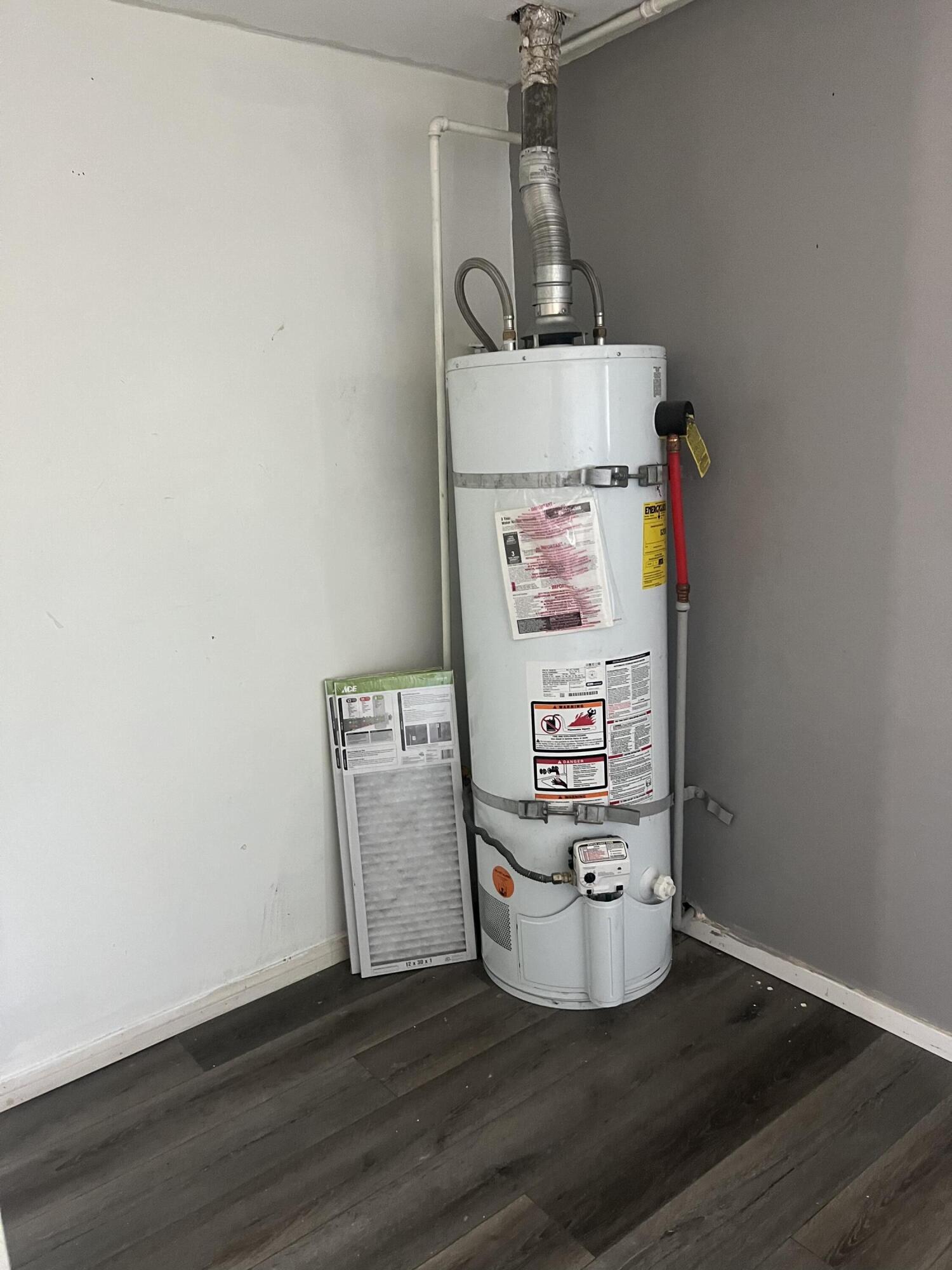 47902 Luzon Street Indio, CA 92201 - Photo 7 of 11 a room with water heater and wooden floor
