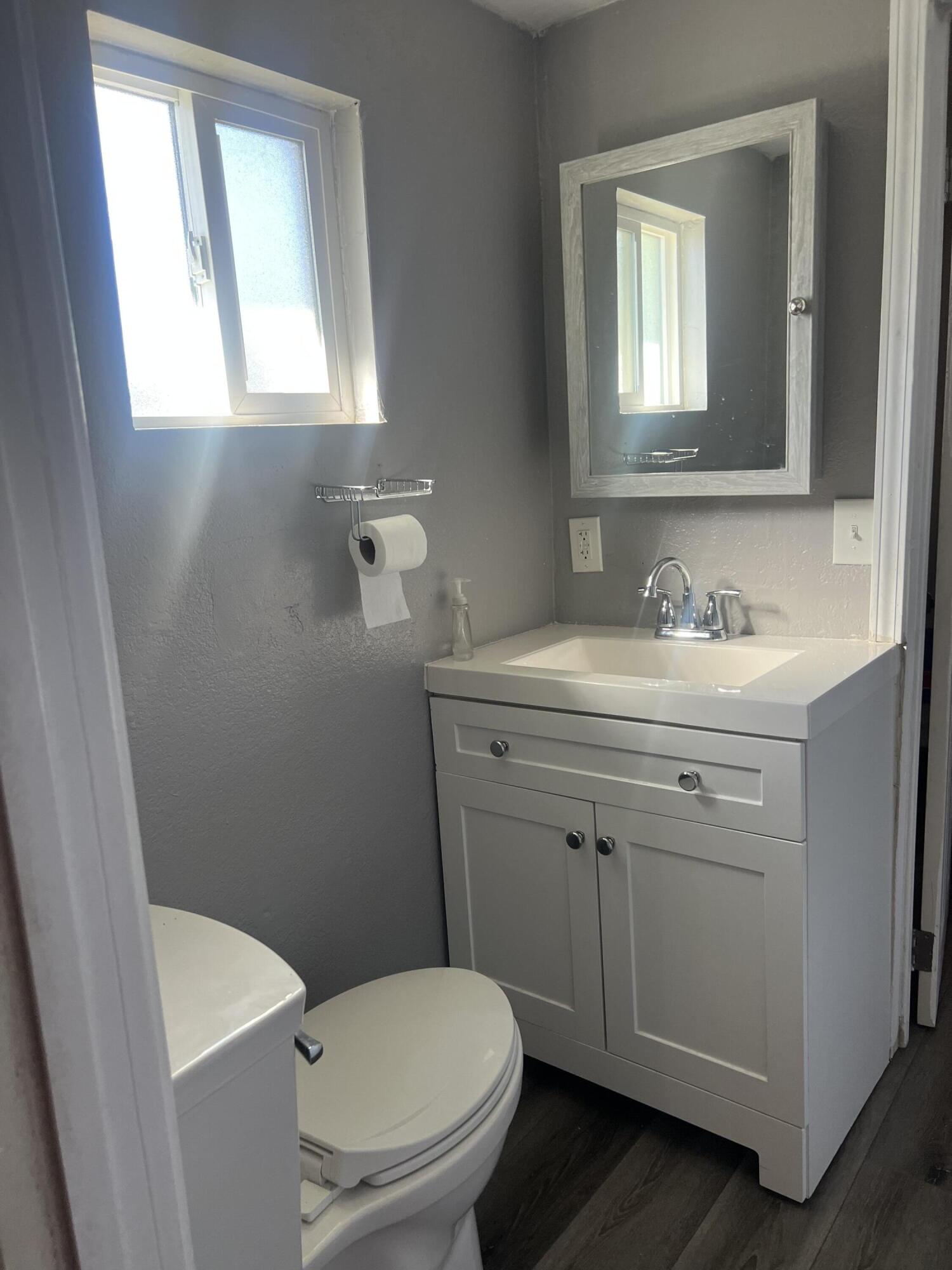 47902 Luzon Street Indio, CA 92201 - Photo 9 of 11 a bathroom with a toilet sink and mirror