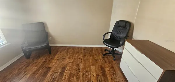 a room with wooden floor and furniture