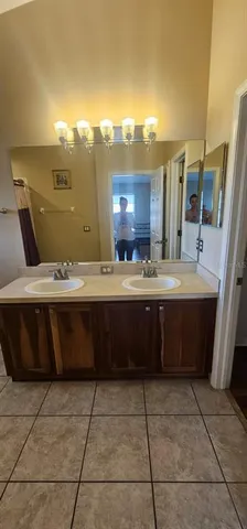 a bathroom with a sink vanity and a mirror