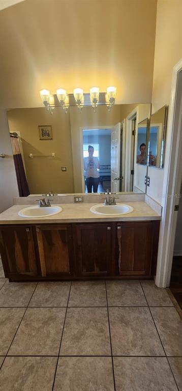 8504 Shallow Creek Court New Port Richey, FL 34653 - Photo 19 of 28 a bathroom with a sink vanity and a mirror