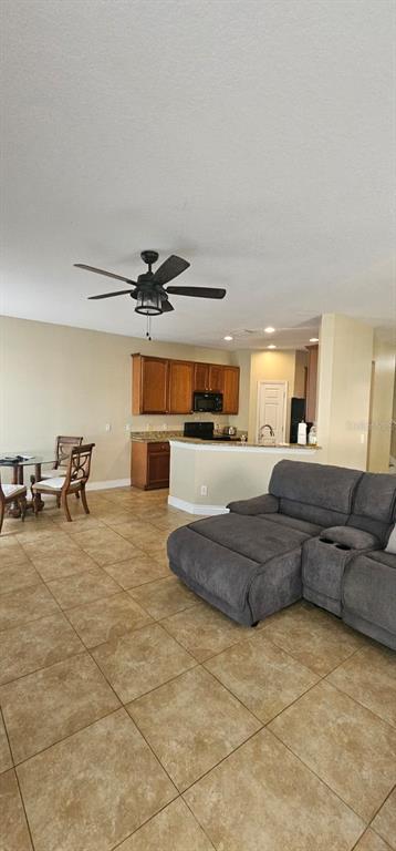 8504 Shallow Creek Court New Port Richey, FL 34653 - Photo 2 of 28 a living room with furniture and a chandelier