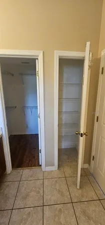 a view of walk in closet with empty racks