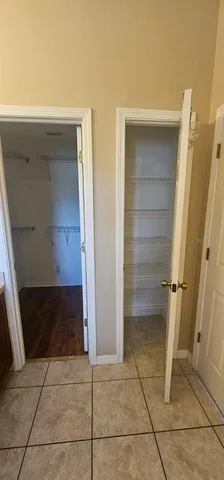 a view of walk in closet with empty racks