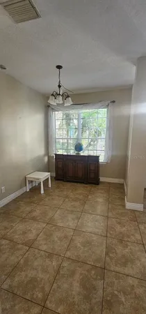 a view of a kitchen with a sink and chandelier