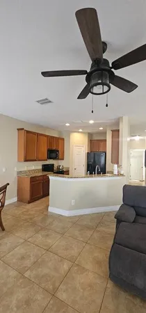 a living room with furniture and kitchen view