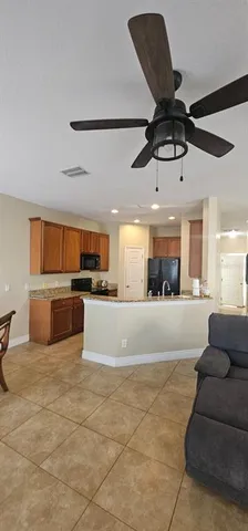 a living room with furniture and kitchen view