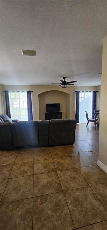 8504 Shallow Creek Court New Port Richey, FL 34653 - Photo 8 of 28 a living room with furniture and a flat screen tv