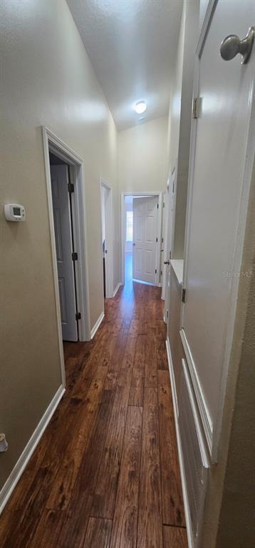 8504 Shallow Creek Court New Port Richey, FL 34653 - Photo 9 of 28 a view of a hallway with wooden floor