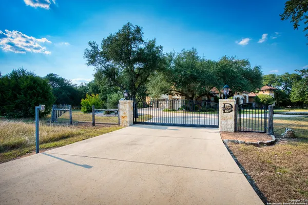 a view of a park with iron fence