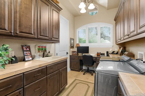 a view of living room kitchen with stainless steel appliances kitchen island granite countertop furniture and fireplace