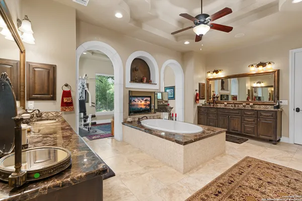 a kitchen with granite countertop a sink stove and cabinets