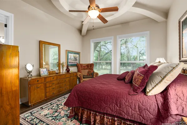 a bedroom with two beds and a potted plant