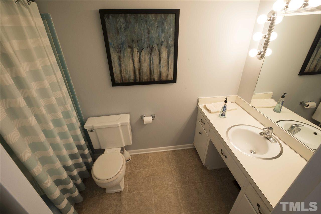2708 Ramsey Road Raleigh, NC 27604 - Photo 11 of 21 a bathroom with a toilet sink and mirror