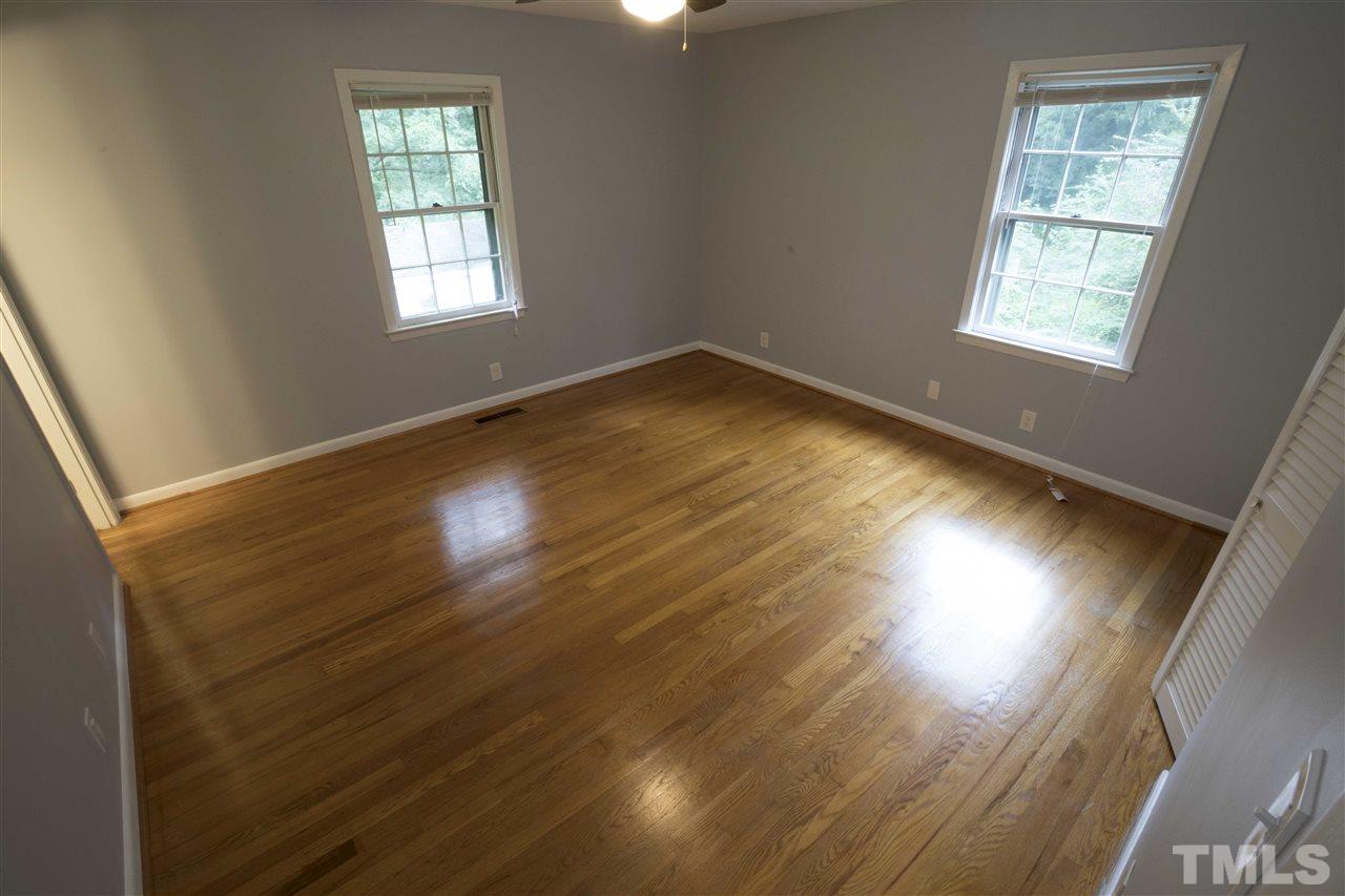 2708 Ramsey Road Raleigh, NC 27604 - Photo 12 of 21 a view of an empty room with wooden floor and a window