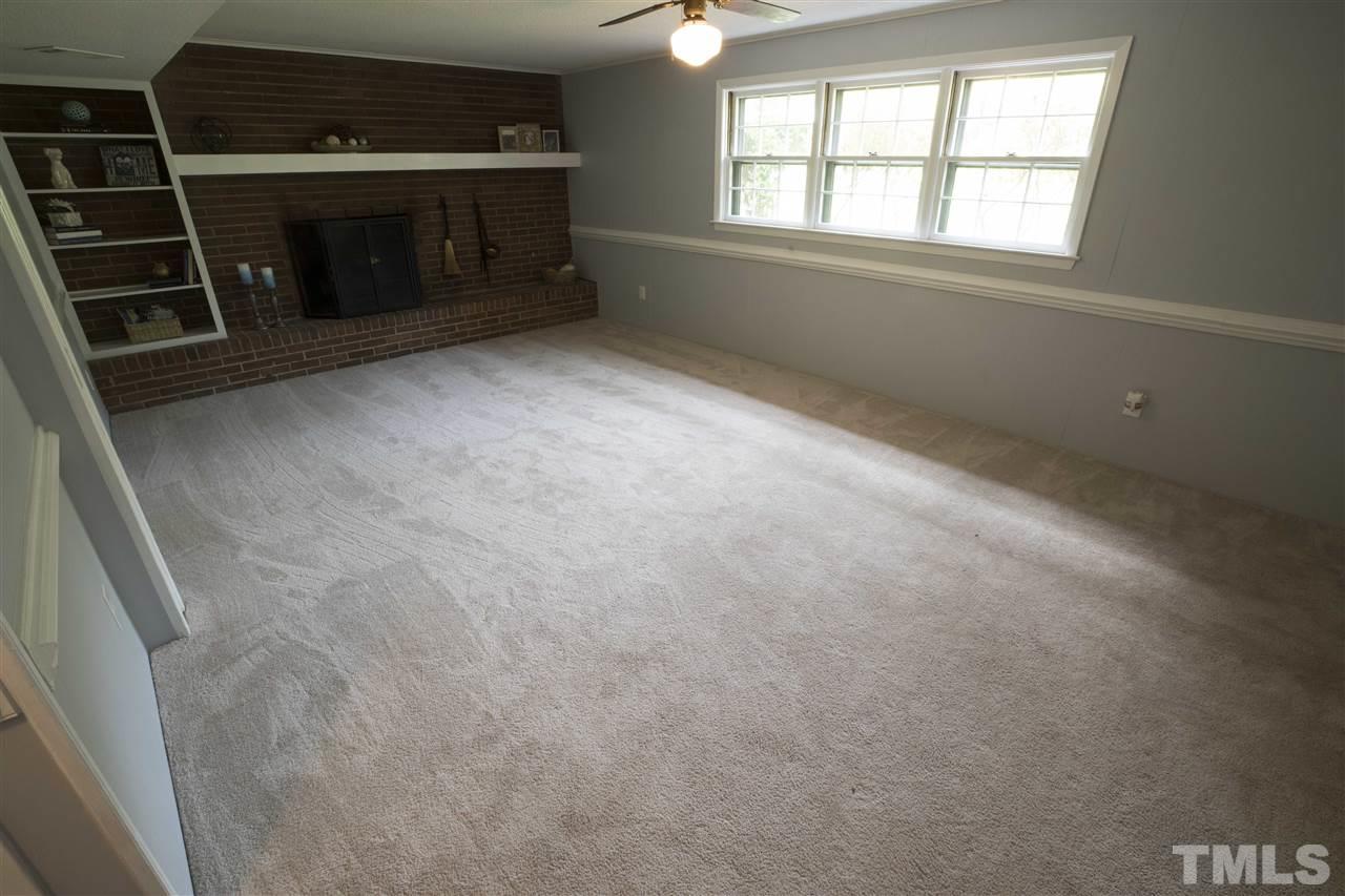 2708 Ramsey Road Raleigh, NC 27604 - Photo 16 of 21 an empty room with a fireplace and windows