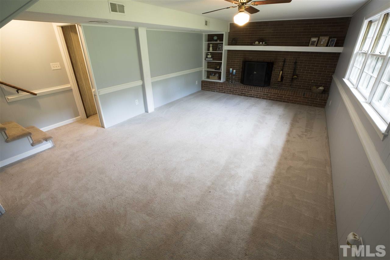 2708 Ramsey Road Raleigh, NC 27604 - Photo 17 of 21 a view of an empty room with fireplace and a window