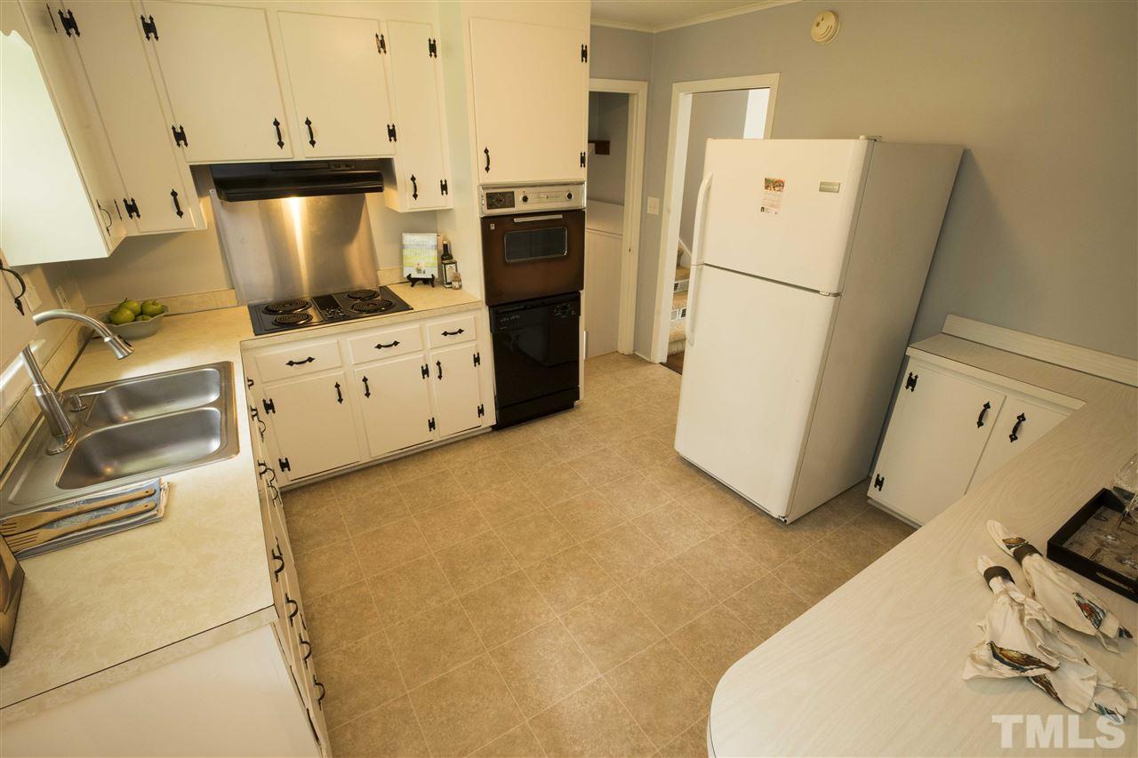 2708 Ramsey Road Raleigh, NC 27604 - Photo 9 of 21 a kitchen with a refrigerator a stove a washer and dryer