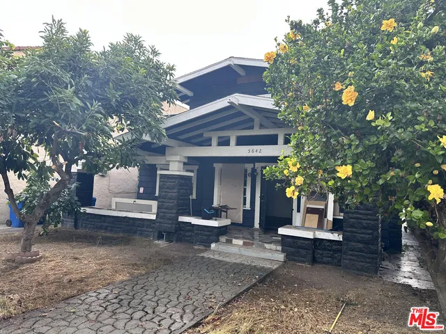 a view of a house with a yard and sitting area