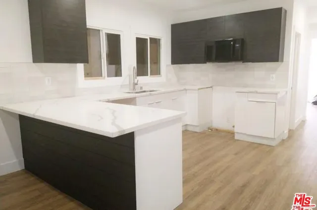 a bathroom with a sink vanity and a mirror
