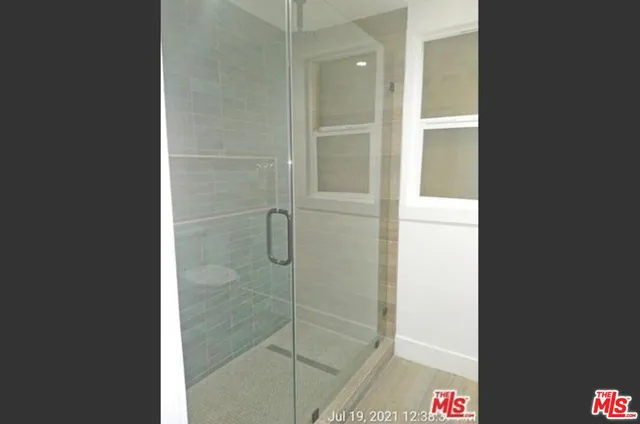 a bathroom with a shower and a sink
