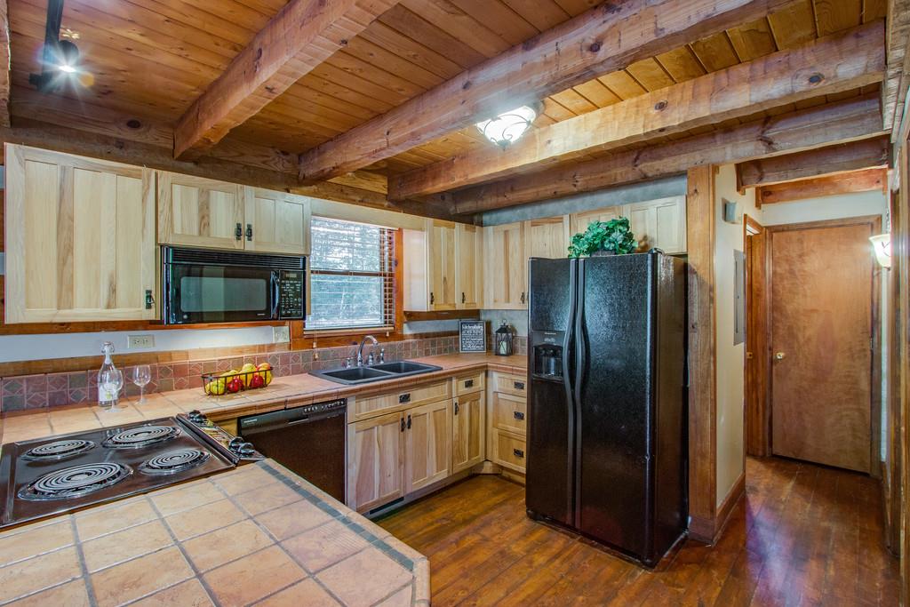 5534 Vanderbilt Road Old Hickory, TN 37138 - Photo 12 of 27 a kitchen with stainless steel appliances granite countertop a refrigerator a sink dishwasher a stove and white countertops with wooden floor