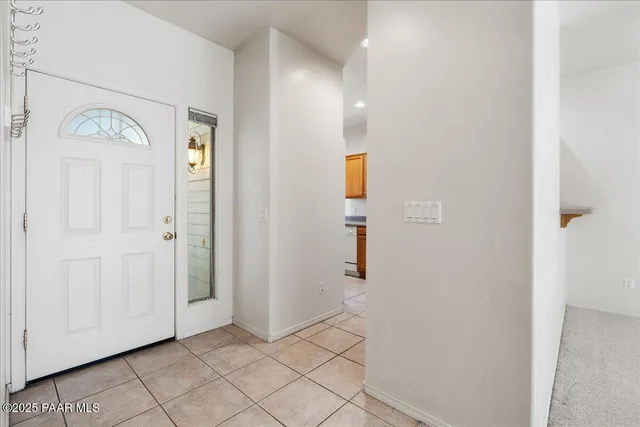 a view of hallway with furniture and a window