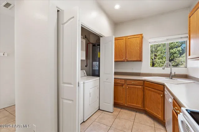 a kitchen with a sink cabinets and a wooden floor