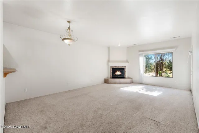 a view of empty room with a fireplace