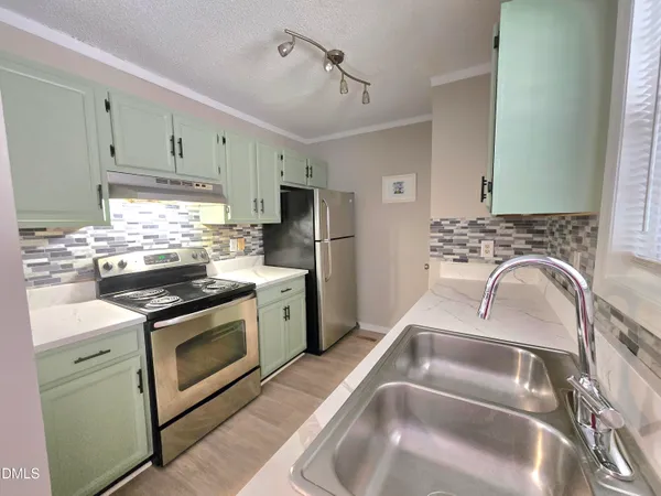 a kitchen with granite countertop a sink stainless steel appliances and cabinets