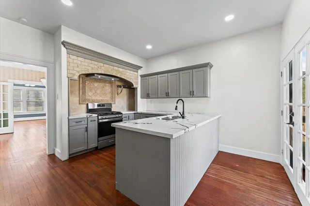 a kitchen with a sink and a stove top oven