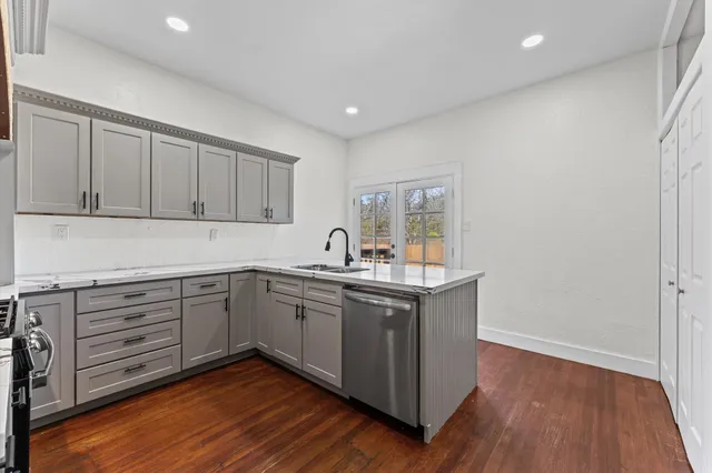a kitchen with sink cabinets and wooden floor
